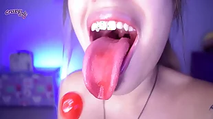 cute girl licking and sucking a lollipop