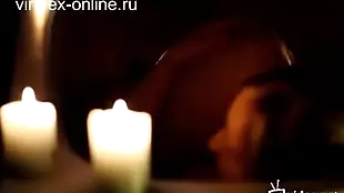 naked woman taking a bath with candles